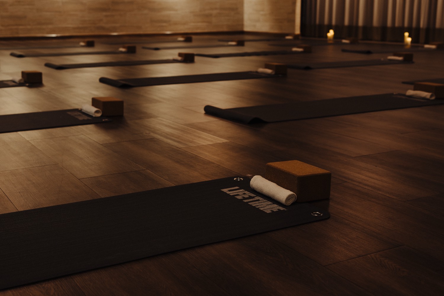 Candlelit yoga studio with mats laid out